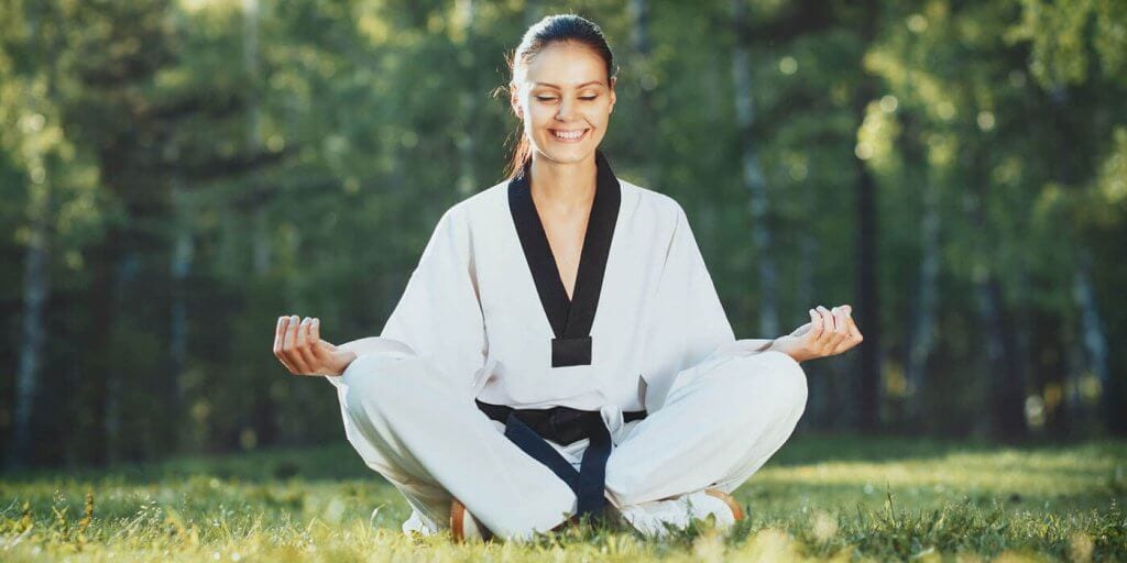 Martial Arts Lessons for Adults in Rockwall TX - Happy Woman Meditated Sitting Background