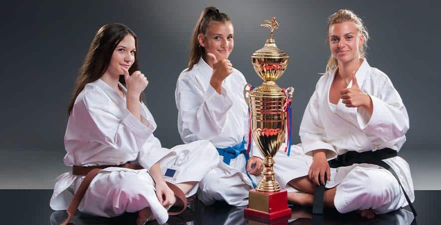 Martial Arts Lessons for Kids in Rockwall TX - Thumbs Up and Trophies with Sitting Girls